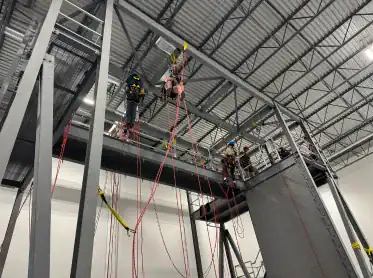 Rope access operative reviewing equipment checks during IRATA Refresher training in Calgary, Canada