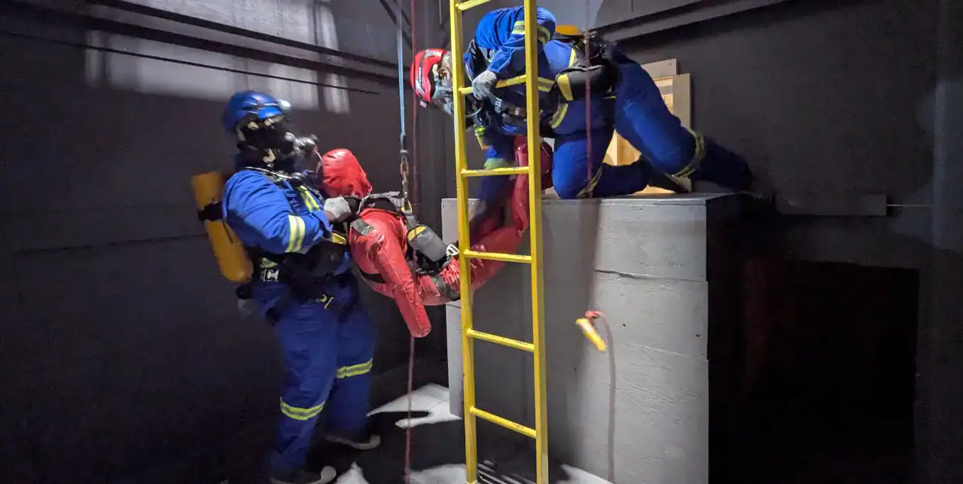 Trainees entering large tunnel during confined space rescue training.