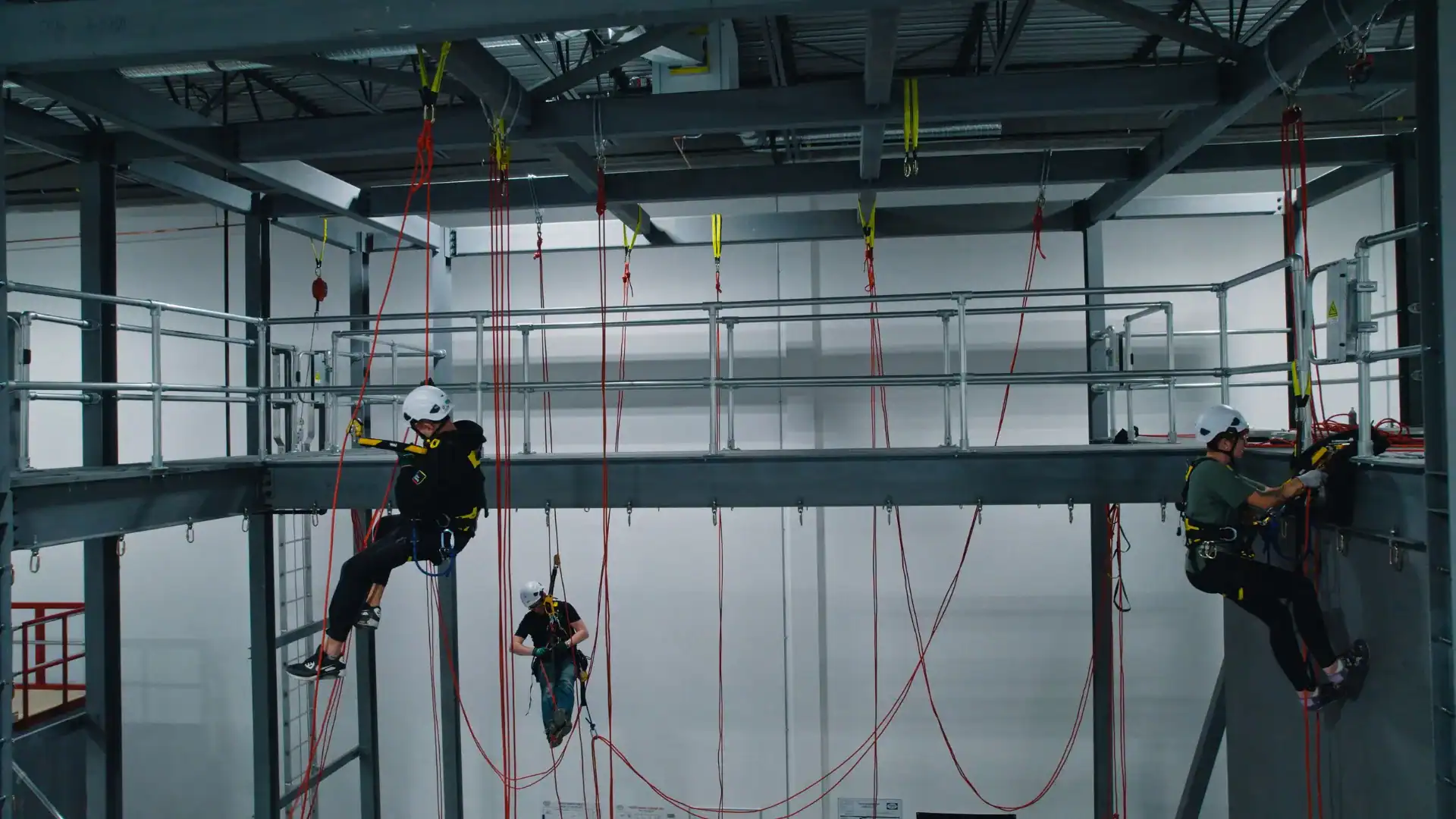 SPRAT rope access training facility in Calgary showing technicians at multiple levels on two-rope systems