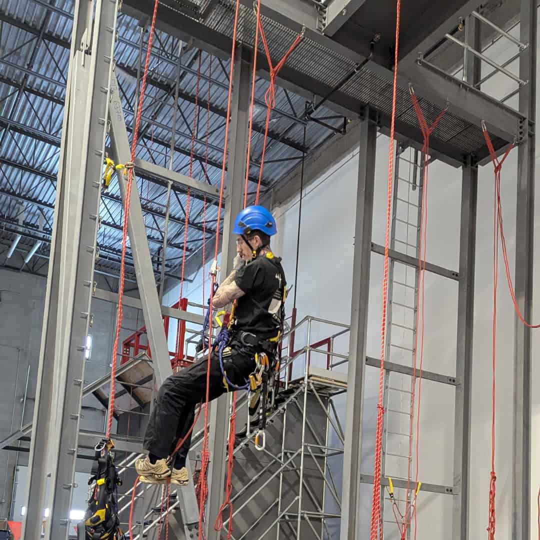 SPRAT rope access technician suspended on two-rope system during training in Calgary